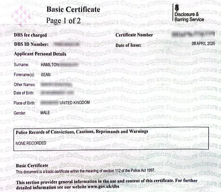 A redacted Basic DBS Disclosure certificate for Sean Hamilton dated 8 April 2026. The certificate header shows the official Disclosure and Barring Service branding. The personal identifiers are blacked out. The result line reads Police Records of Convictions, Cautions, Reprimands and Warnings: NONE RECORDED. The redacted version is displayed on the About page. The original is available in person on request.